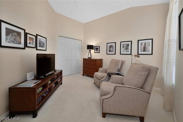 living area with lofted ceiling and light carpet