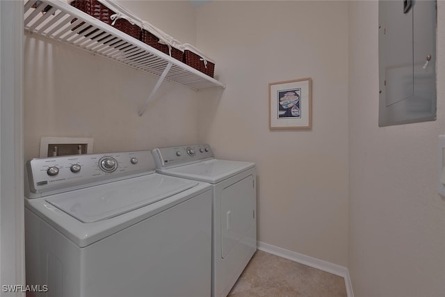 clothes washing area with washer and dryer and electric panel