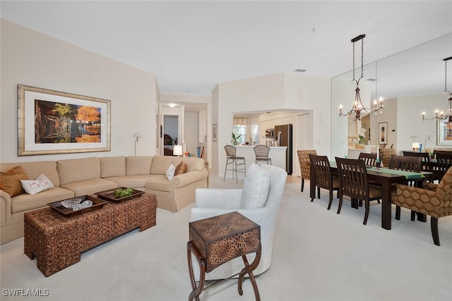 living room with a chandelier and carpet flooring