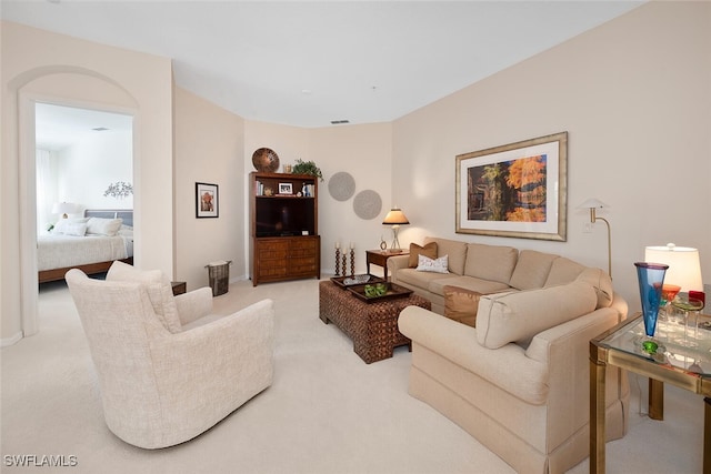 living area featuring light carpet and visible vents