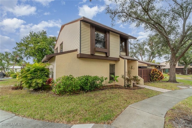 view of side of home with a yard