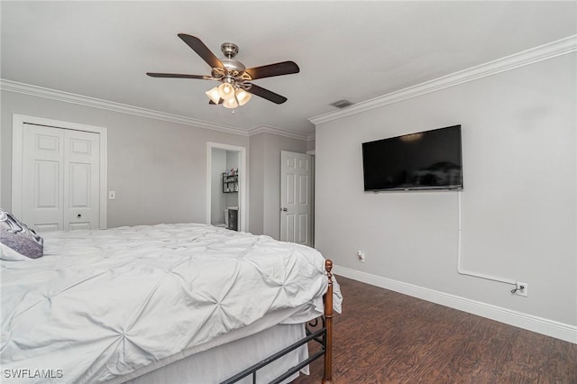 bedroom featuring ornamental molding, a closet, ceiling fan, and dark wood-type flooring