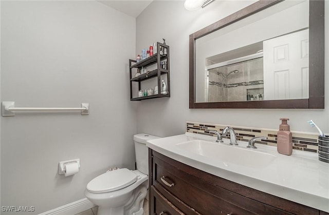 bathroom featuring vanity, tasteful backsplash, toilet, and an enclosed shower