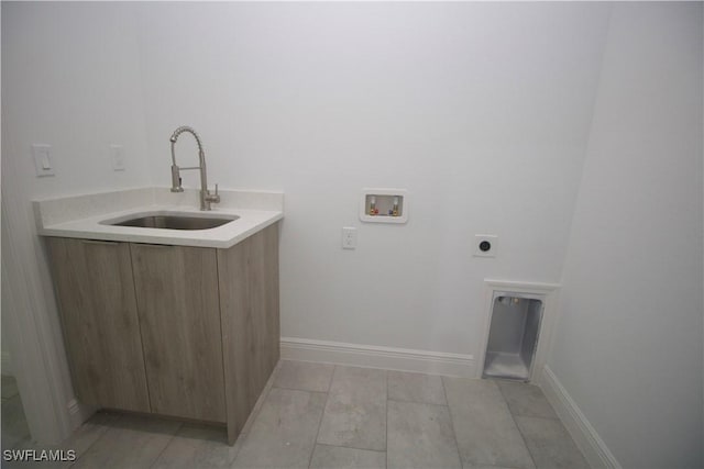 laundry room featuring sink, light hardwood / wood-style flooring, washer hookup, and hookup for an electric dryer