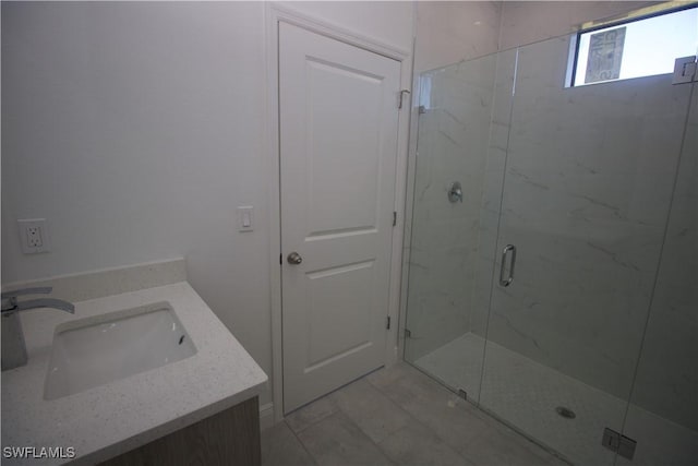 bathroom with vanity and a shower with shower door