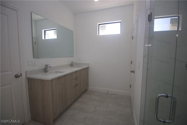 bathroom featuring vanity, walk in shower, and a wealth of natural light