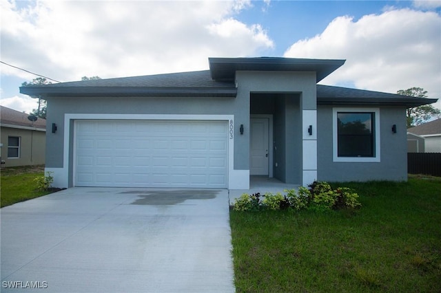 view of front of property with stucco siding, concrete driveway, and an attached garage