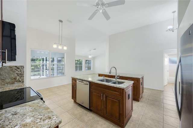 kitchen with ceiling fan with notable chandelier, sink, an island with sink, appliances with stainless steel finishes, and decorative light fixtures