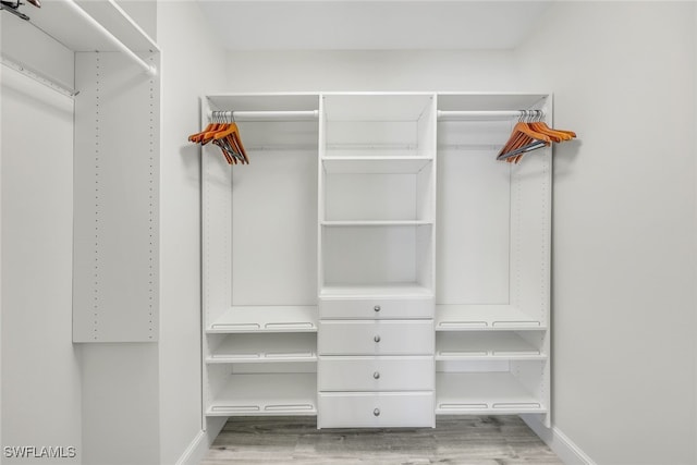 spacious closet with light hardwood / wood-style floors