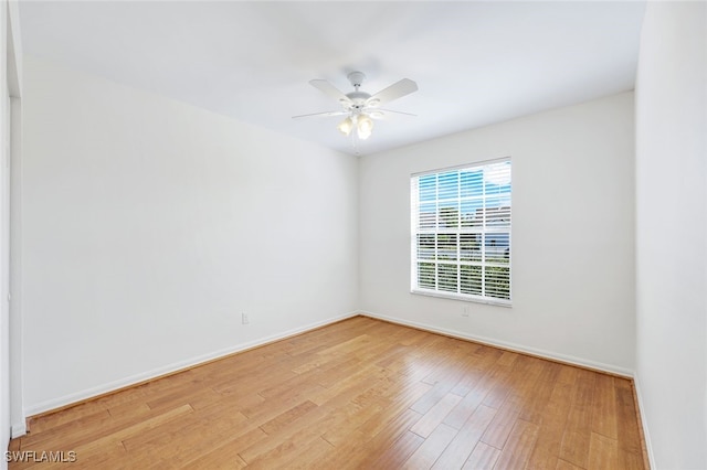 unfurnished room with light wood-type flooring and ceiling fan