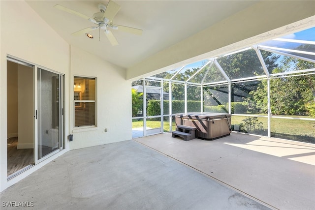 view of patio / terrace with ceiling fan, a lanai, and a hot tub