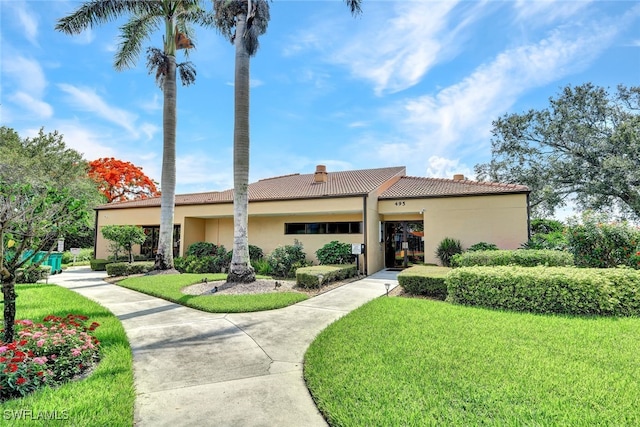 mediterranean / spanish-style home featuring a front lawn