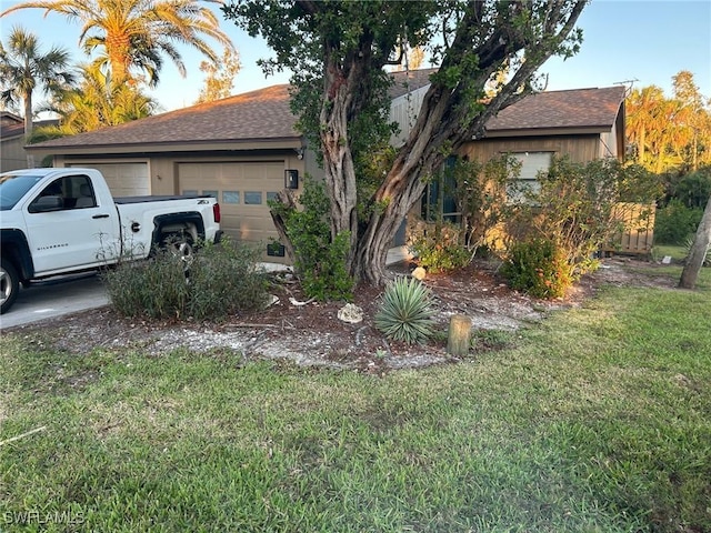 exterior space featuring a yard and a garage