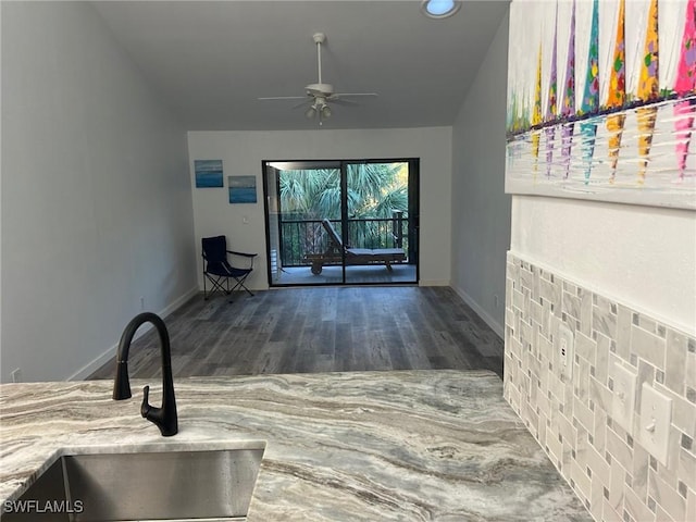 unfurnished living room with ceiling fan, dark hardwood / wood-style flooring, and sink