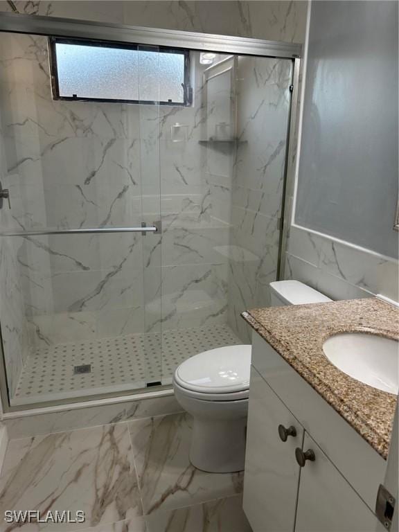 17658 Osprey Inlet Ct W, Fort Myers, FL 33908 - full bathroom featuring vanity, marble finish floors, a marble finish shower, and tile walls