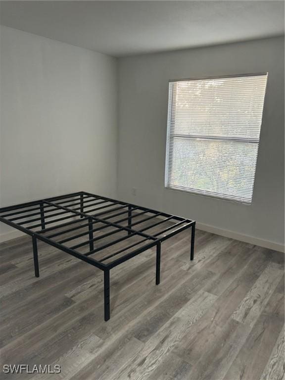 17658 Osprey Inlet Ct W, Fort Myers, FL 33908 - unfurnished bedroom with wood finished floors and baseboards