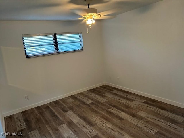 empty room featuring dark hardwood / wood-style floors, ceiling fan, and lofted ceiling