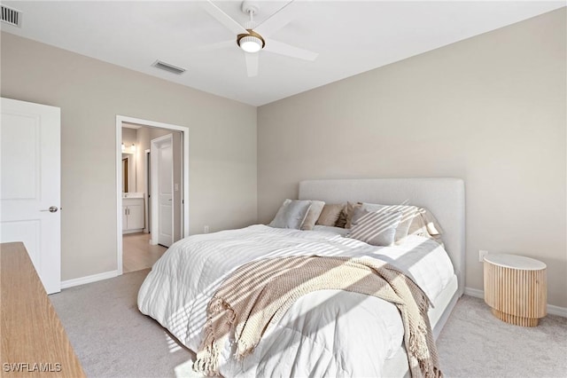 carpeted bedroom with ceiling fan and connected bathroom