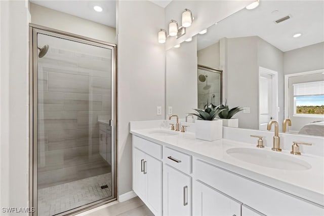 bathroom featuring vanity, hardwood / wood-style flooring, and walk in shower