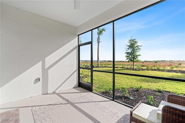 unfurnished sunroom with a rural view