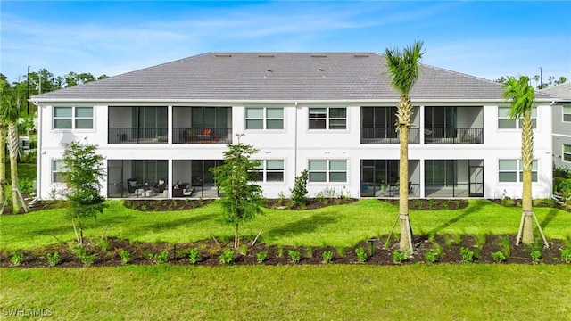 rear view of property featuring a yard