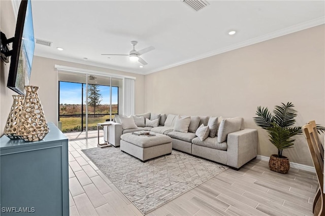 living room with light hardwood / wood-style floors, ceiling fan, and crown molding