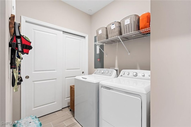 washroom featuring separate washer and dryer and light hardwood / wood-style floors