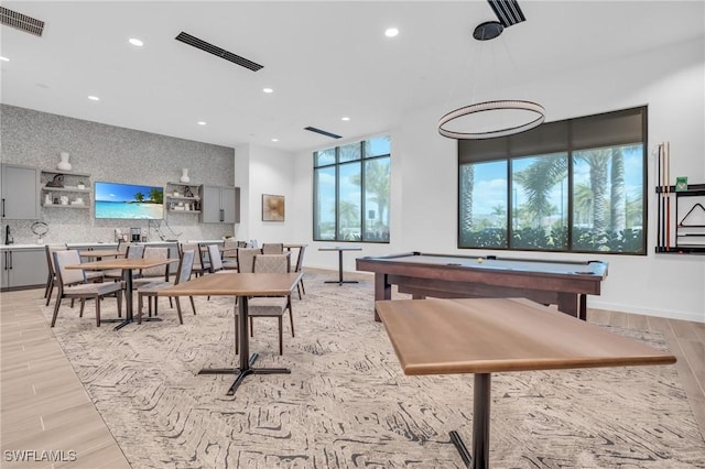 game room with light wood-type flooring and pool table