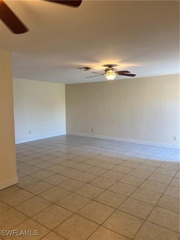 empty room featuring ceiling fan and light tile patterned flooring