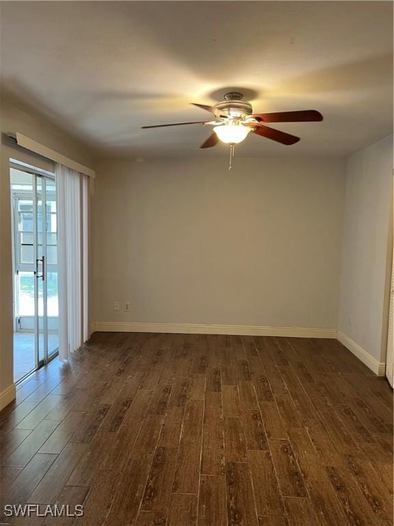 unfurnished room with dark hardwood / wood-style flooring and ceiling fan