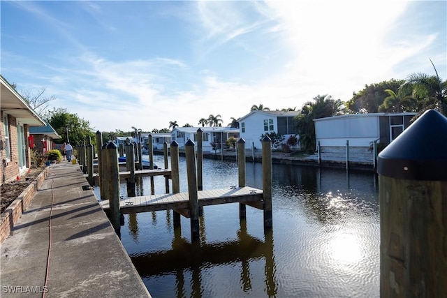 dock area with a residential view and a water view