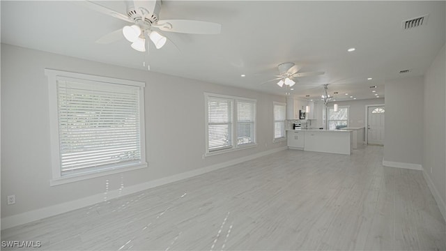 unfurnished living room featuring baseboards, visible vents, ceiling fan, light wood-style flooring, and recessed lighting