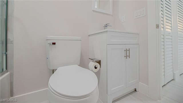 bathroom with a closet, shower / bath combination with glass door, and toilet