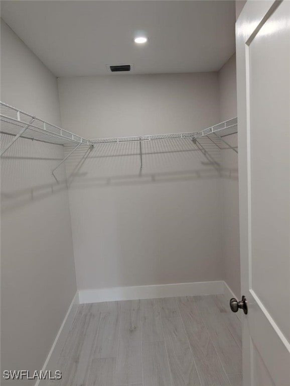2836 Arbutus St Unit A1, Naples, FL 34112 - walk in closet with wood finished floors