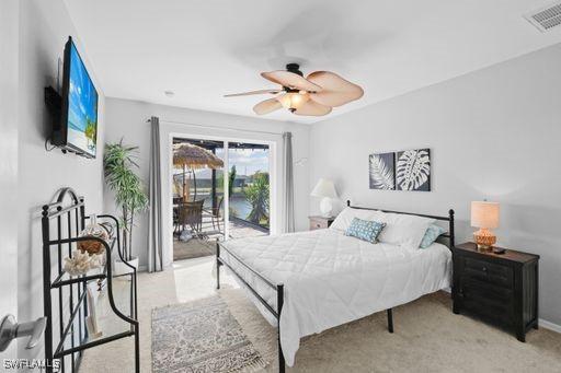 bedroom featuring ceiling fan, light colored carpet, and access to outside