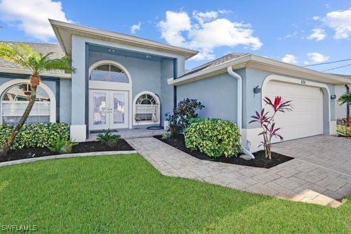 doorway to property with a lawn and a garage