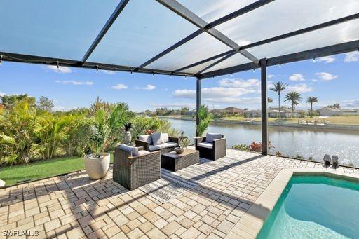 view of patio / terrace with a lanai, a water view, and an outdoor hangout area