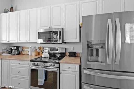 kitchen featuring white cabinets and appliances with stainless steel finishes