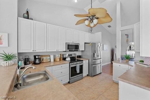 kitchen with white cabinetry, sink, high vaulted ceiling, and stainless steel appliances