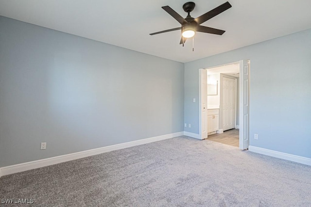 spare room featuring light colored carpet and ceiling fan