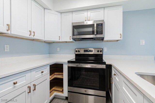 kitchen with stainless steel appliances and white cabinets