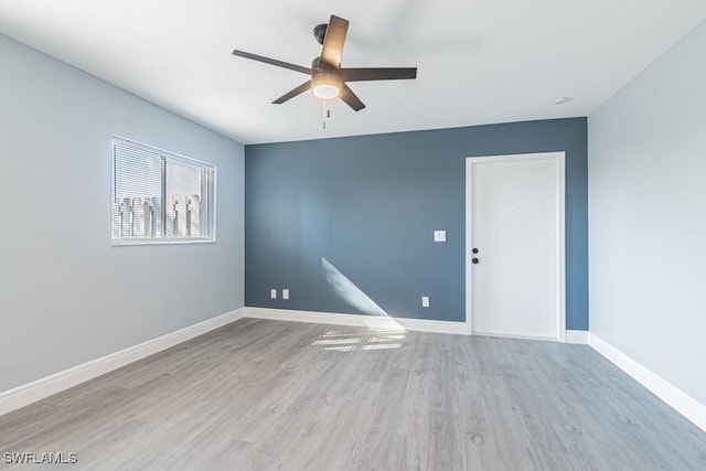 spare room featuring ceiling fan and light hardwood / wood-style flooring