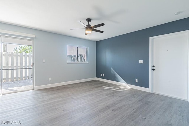 empty room with wood-type flooring and ceiling fan