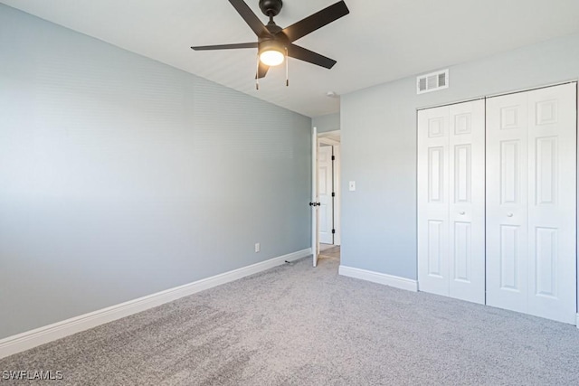 unfurnished bedroom featuring carpet flooring, ceiling fan, and a closet