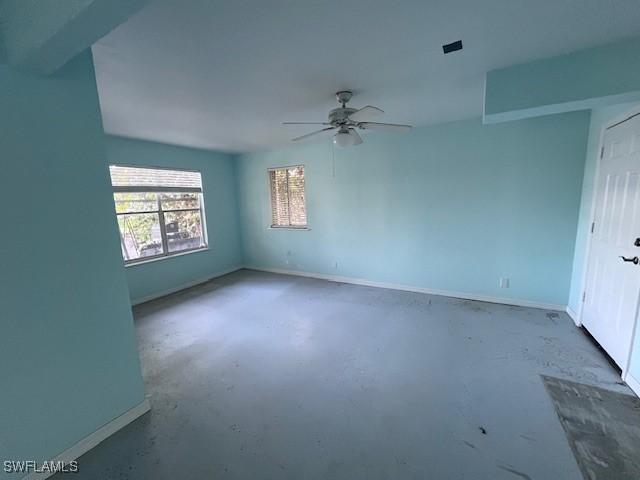 empty room featuring concrete flooring and ceiling fan