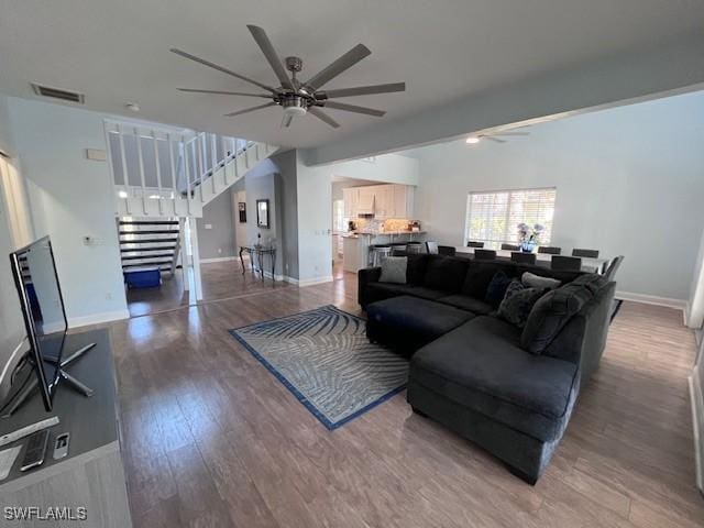 living room featuring hardwood / wood-style flooring and ceiling fan