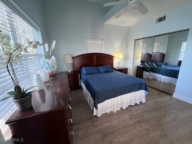 bedroom with ceiling fan, dark hardwood / wood-style floors, and a closet