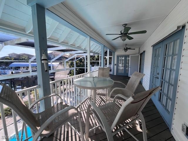 sunroom featuring french doors and ceiling fan