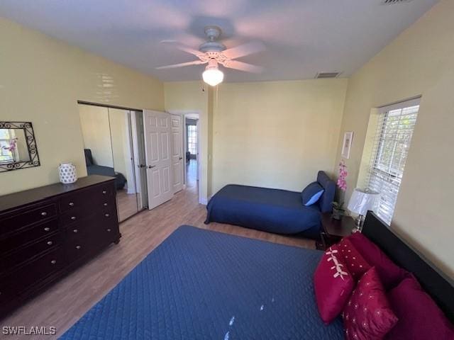 bedroom with a closet, ceiling fan, and light hardwood / wood-style flooring