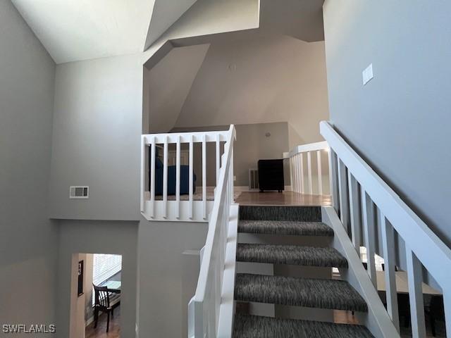 stairway with high vaulted ceiling